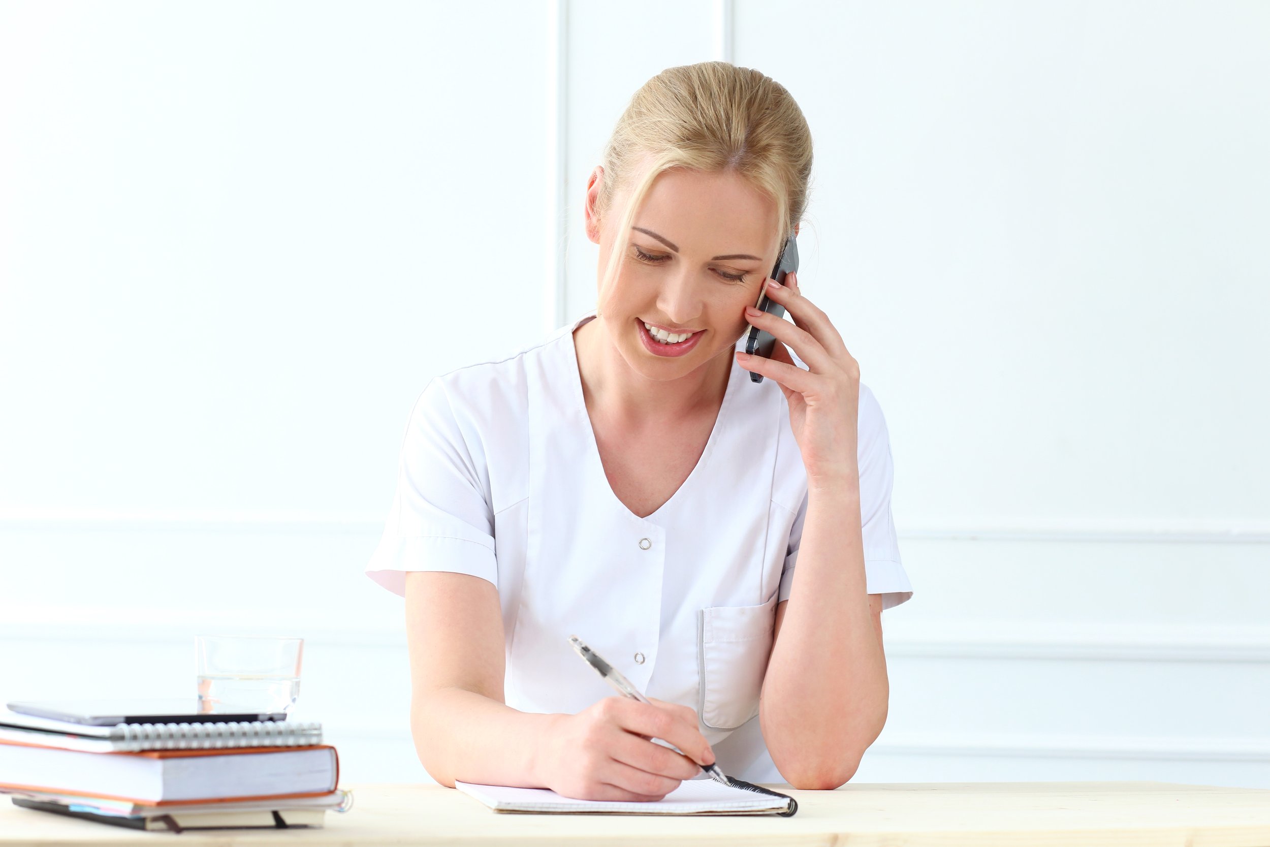 Female healthcare professional managing injury documentation and communication.