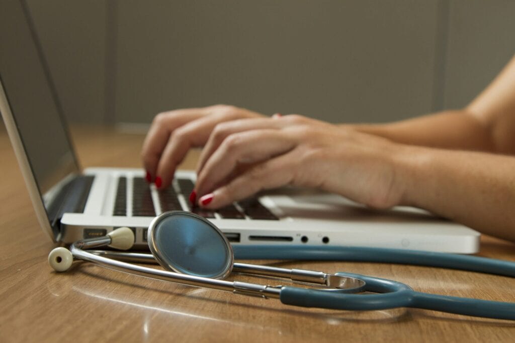 Stethoscope and laptop used for health and safety consulting services.